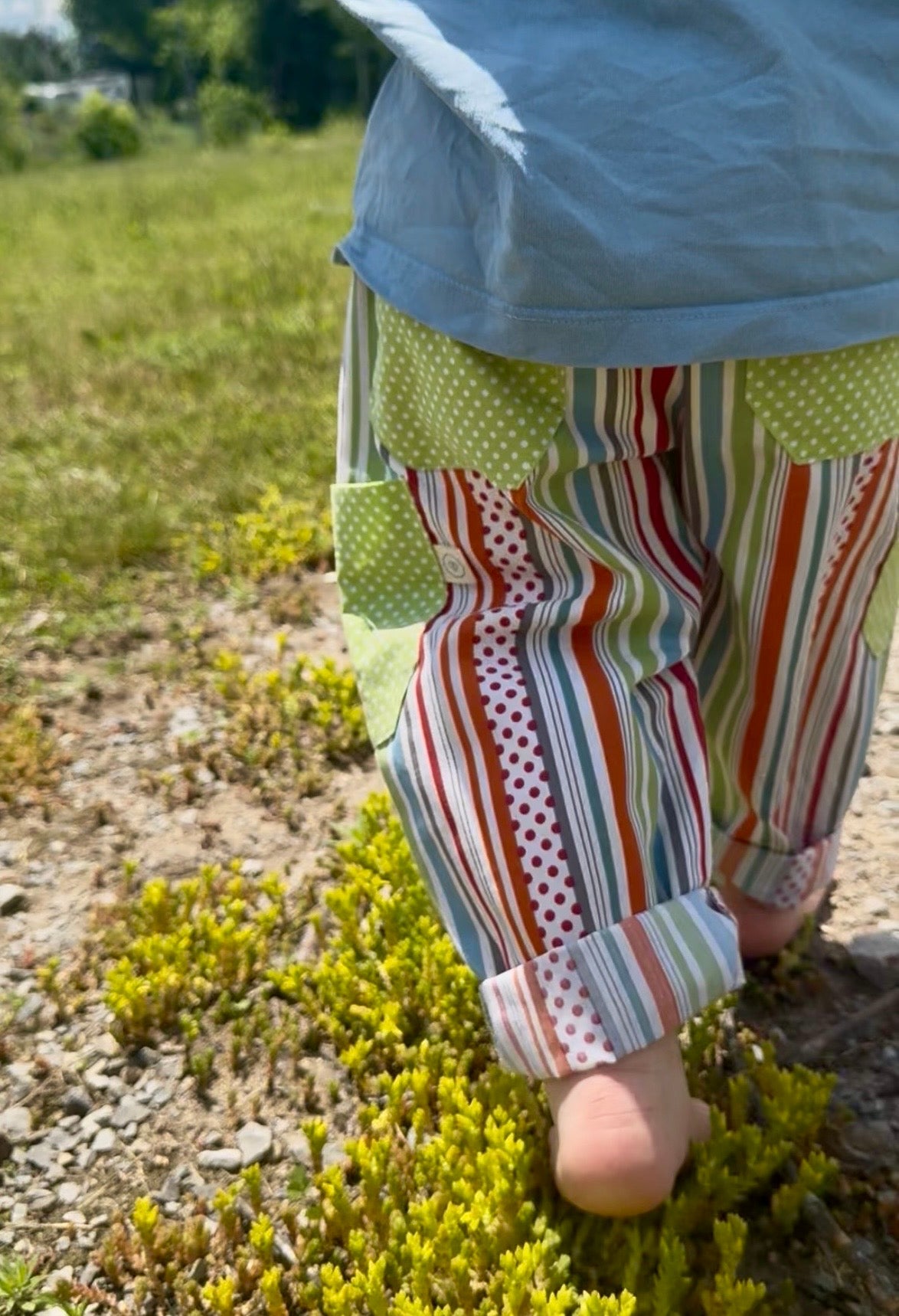 child walking in colourful pants
